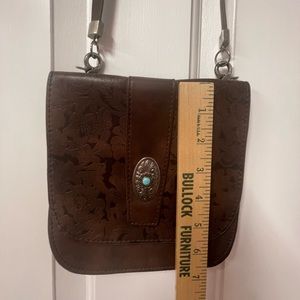 Excellent used condition brown genuine leather crossbody with turquoise detail